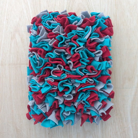 a large blue red grey snuffle mat