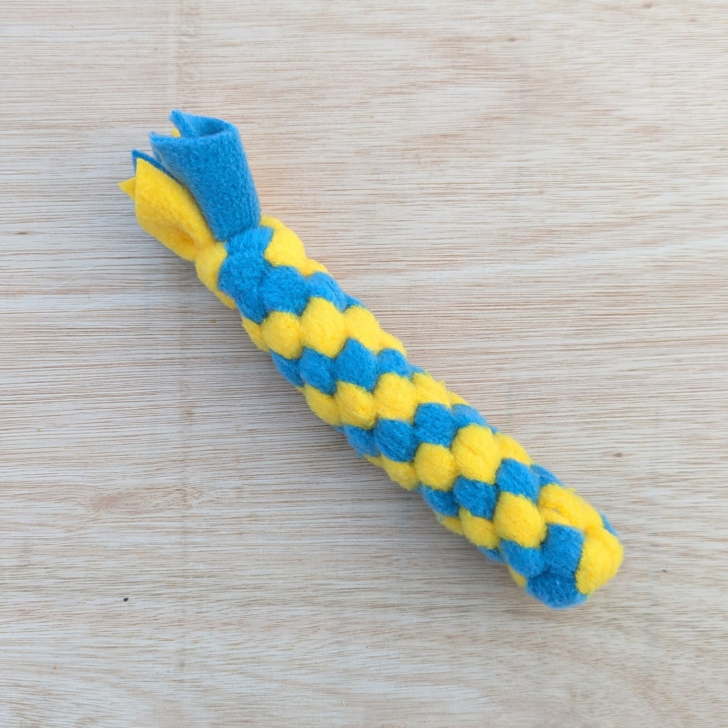 a 20cm blue and yellow, woven fleece tug scent toy