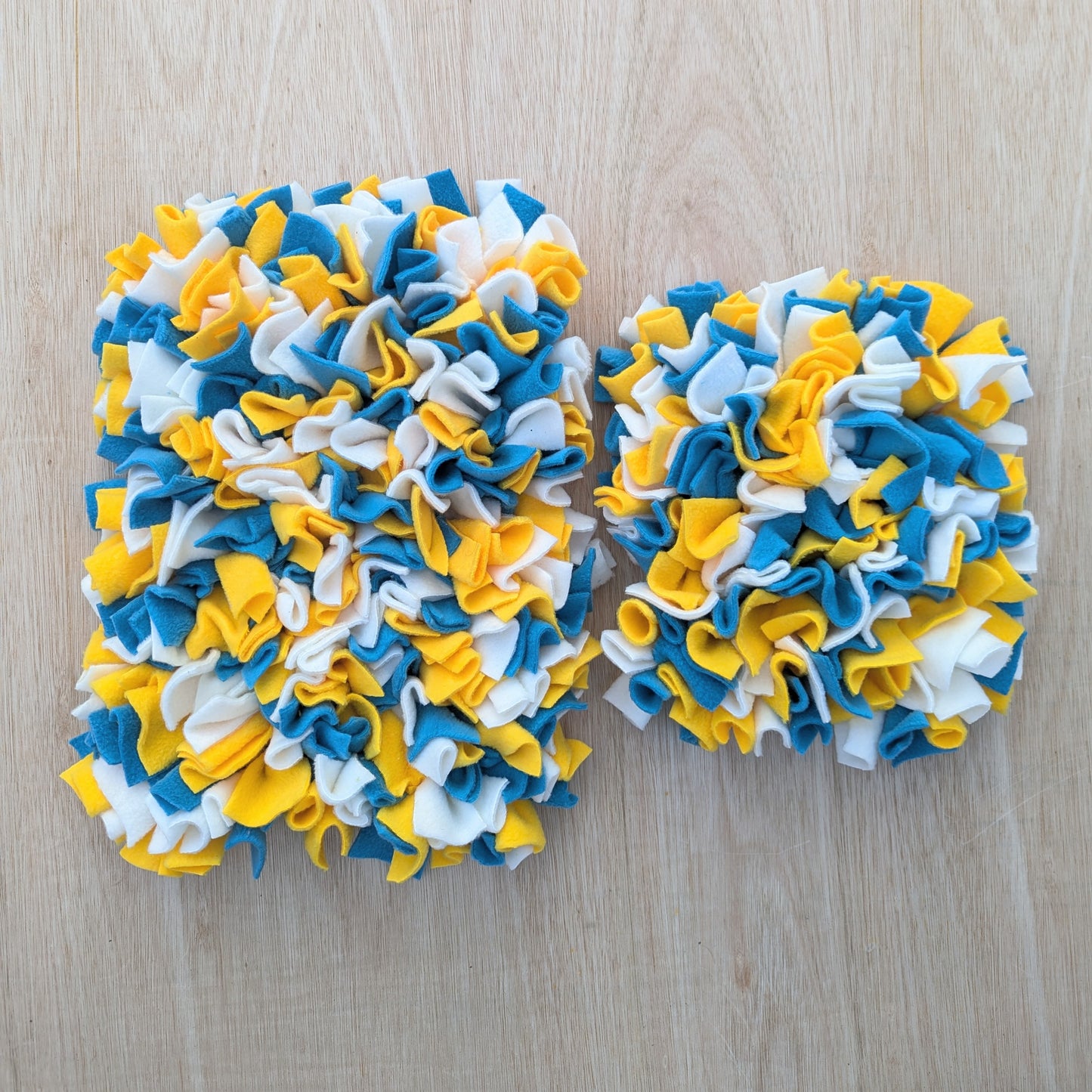 the large snuffle mat is on the left and the small snuffle mat is on the right