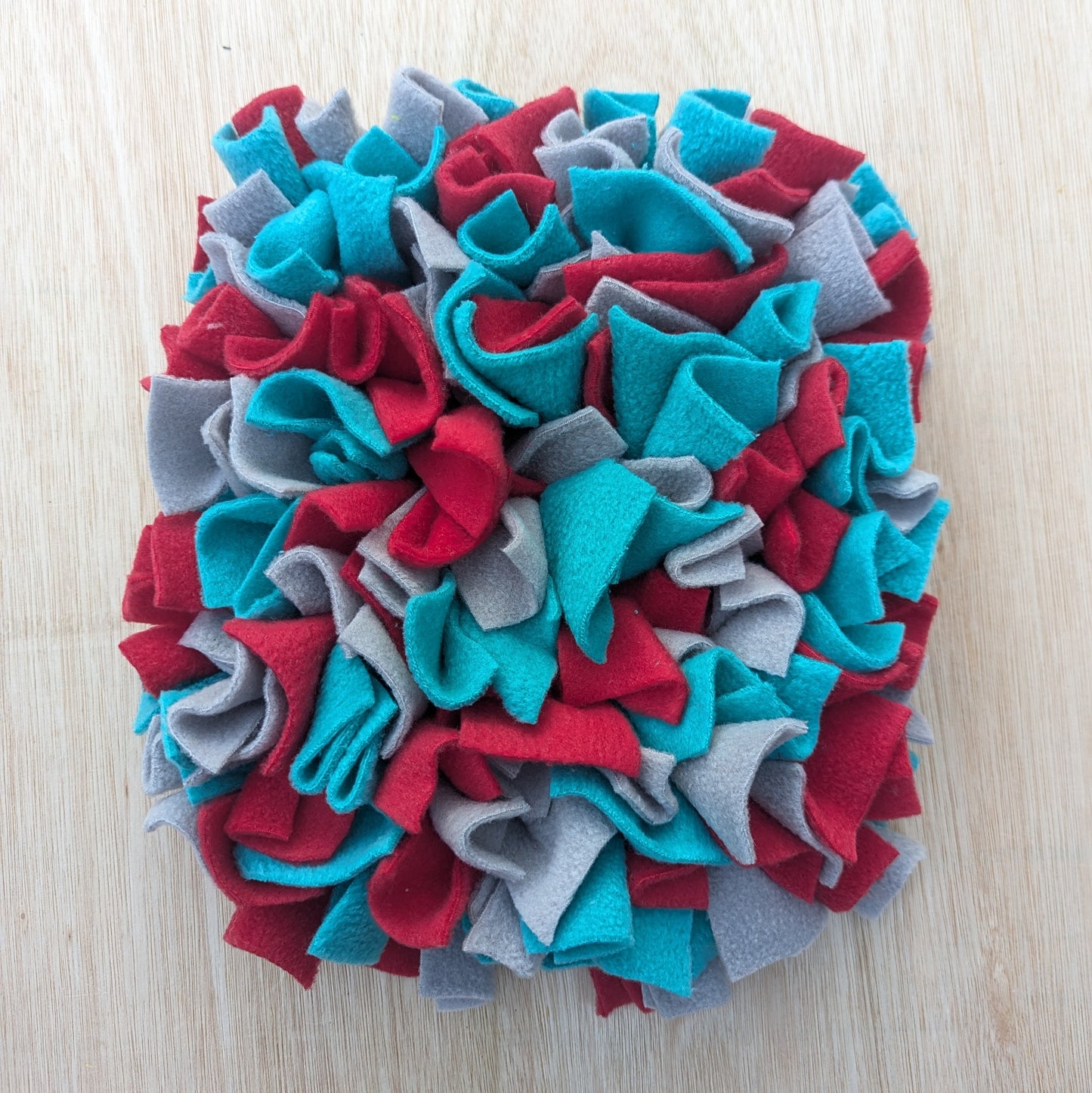 a small blue red grey snuffle mat