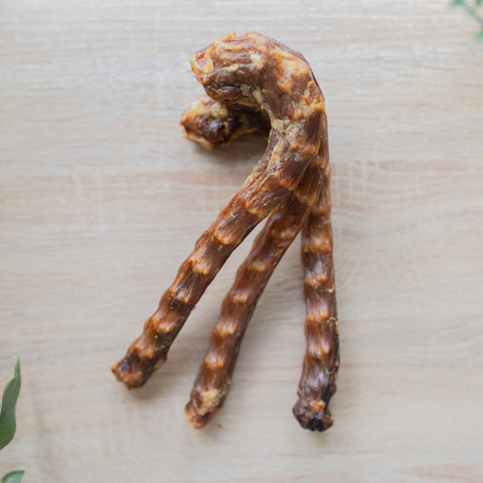 Three goose necks, the hook shape top are piled on top of each other, they are at the top of the photo. The long portion of the necks are vertically down but fanned out