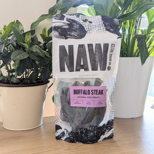 the buffalo steak is in a black and white bag that's clear in the middle. The paddywhack is in amongst some plants, a taller one at the back,  shorter one to the left side