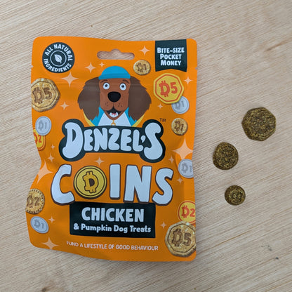 Denzel's Coins Chicken & Pumpkin Dog Treats packaging on a wooden surface with treats beside it on the right