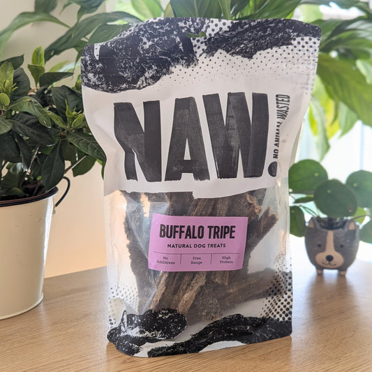 the tripe is in a black and white bag that's clear in the middle. The paddywhack is in amongst some plants, a taller one at the back,  shorter one to the left side and a small at the back on the right