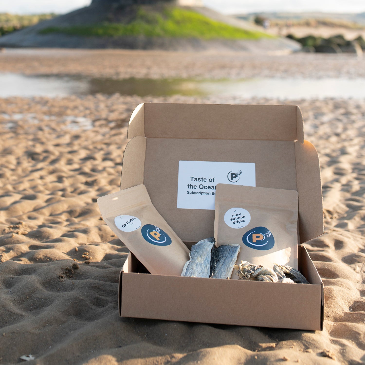 Box with 'Taste of the Ocean' products on a beach