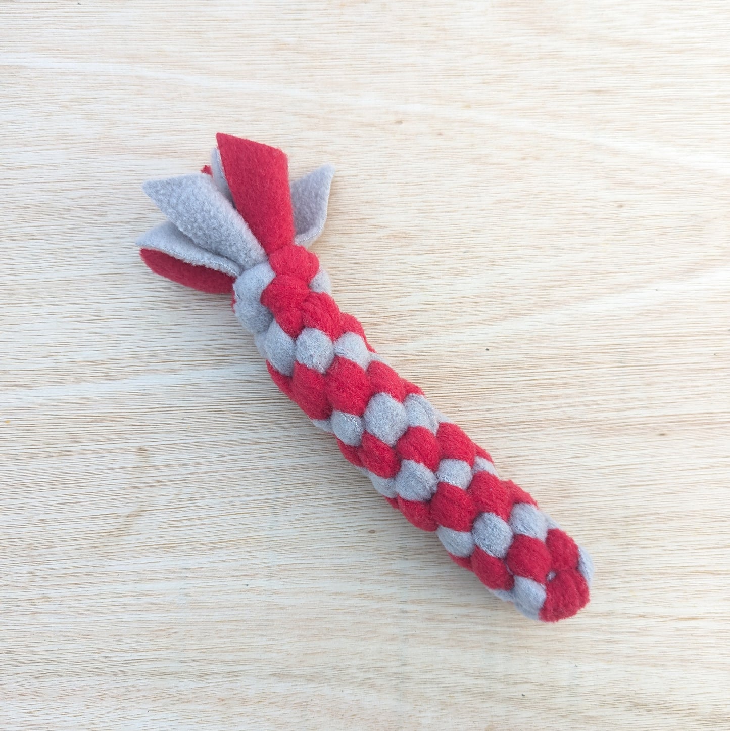a 20cm red and grey, woven fleece tug scent toy