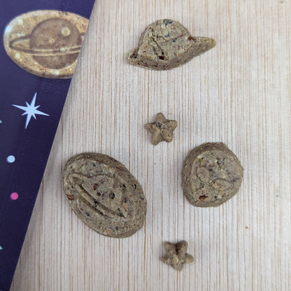 Denzels space mix treats shaped like planets and stars on a wooden surface.