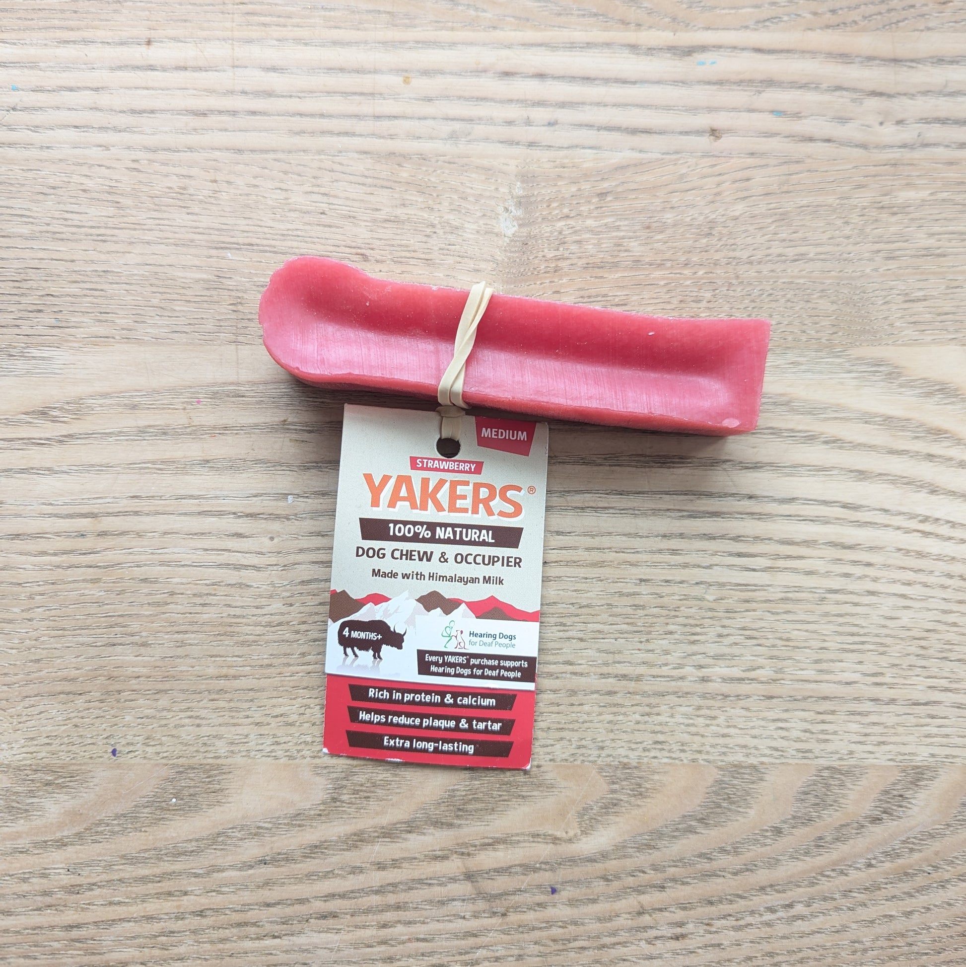 one single yakers yak strawberry chew with an elastic band around the chew 